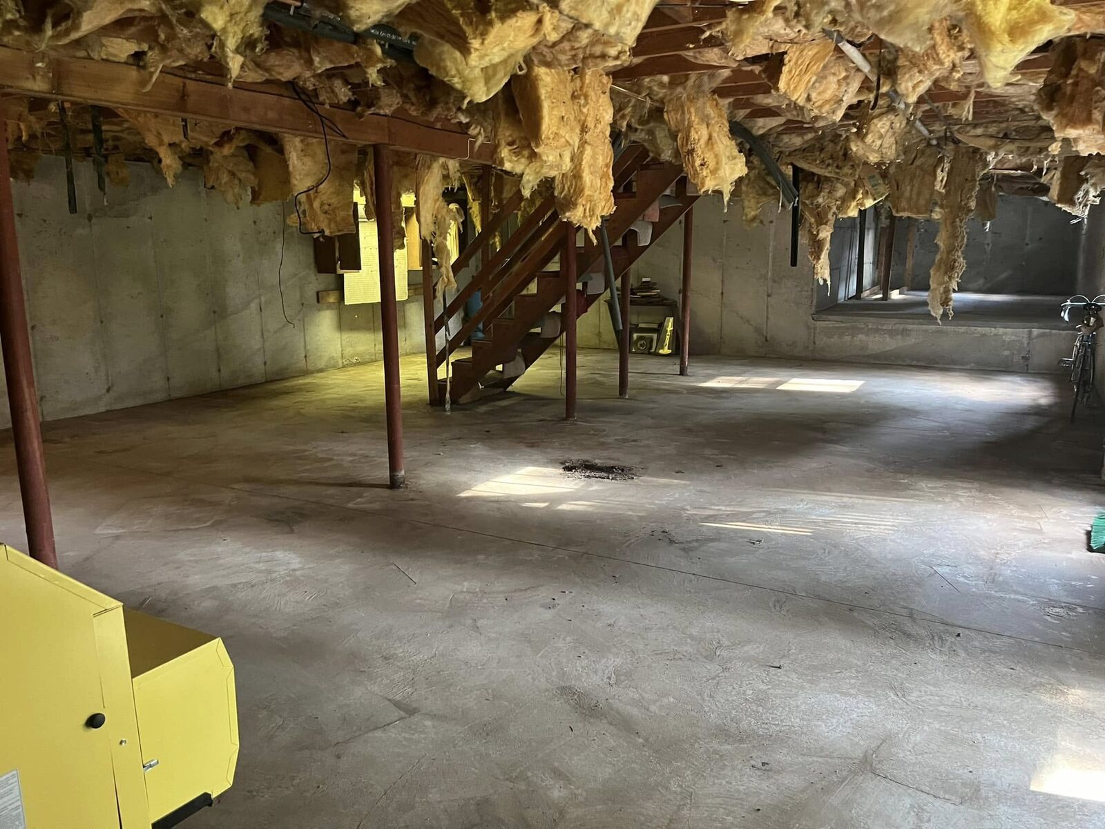 After: the same basement emptied down to a clear floor