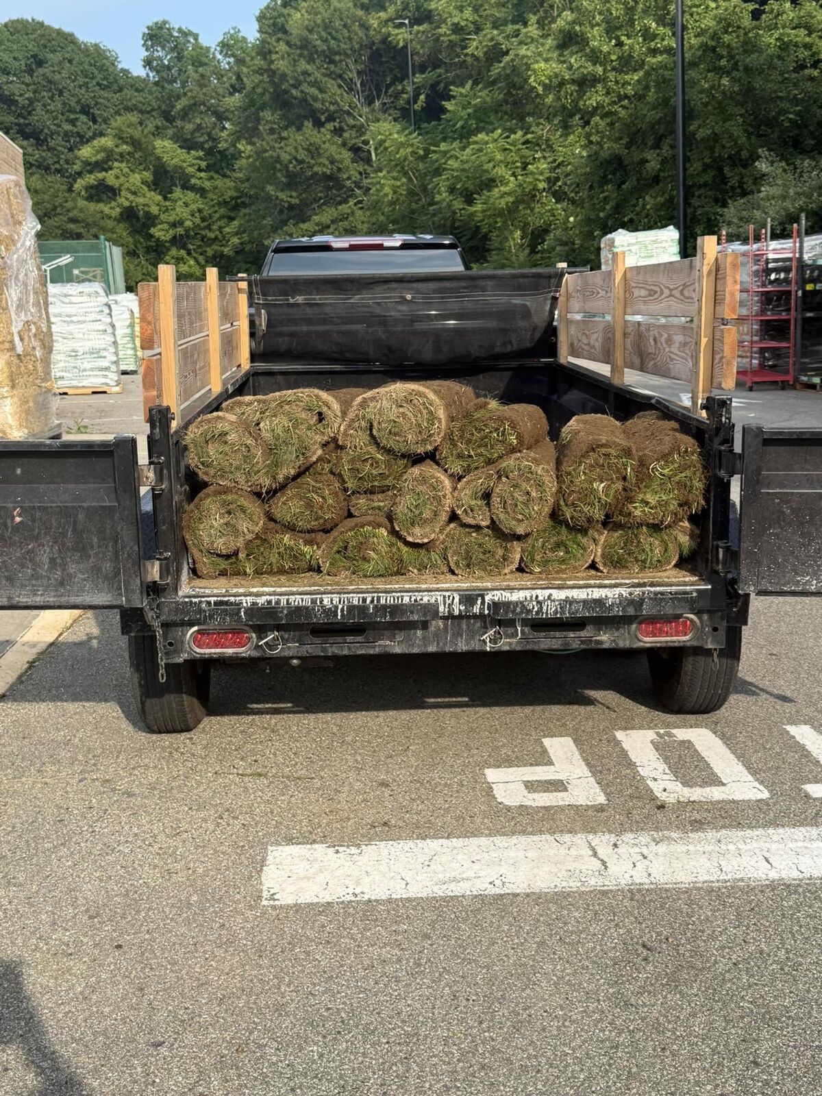 Trailer loaded with rolls of fresh sod for a Jays Property Services LLC landscape project